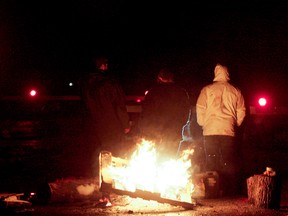 Mohawk protesters block a railway line on the Tyendinaga Mohawk Territory between Belleville and Deseronto, Ont. as part of the national Idle No More protests. The protest began peacefully around 4 p.m., they said, with Ontario Provincial Police keeping their distance. Luke Hendry/The Intelligencer/QMI Agency