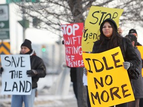 Idle No More protesters hold placards during a demonstration near the Canadian Museum for Human Rights in Winnipeg on  Jan. 07, (QMI AGENCY)