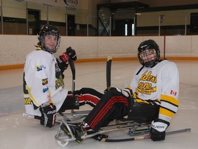 Tyler Carmichael, left, a member of Canada's mens sledge hockey team, came to West Lorne Wednesday to give James Dunn, right, of West Lorne some tips on how sledge hockey is played.