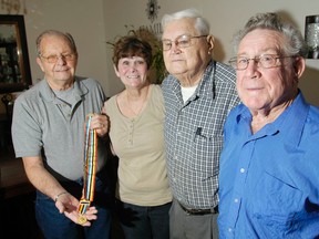 Kingston veterans of the Korean War, from left, Tony Elliott, Tom Boutillier and Leo McHale, along with Sandra Delorme-Elliott, secretary of the local chapter of the Korean Veteran Association of Canada  attended a ceremony where area veterans received South Korean Ambassador of Peace medals for their service in the Korean War.