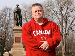 Kingston's Arthur Milnes in front of the statue of Canada's first prime minister at City Park.