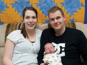 Karen and Justin Chapman hold Josiah, Airdrie’s first baby of 2013 in their home last week. Josiah was born at 12:51 p.m. on January 1. 
JAMES EMERY/AIRDRIE ECHO