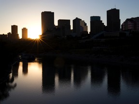 The sun sets behind the downtown skyline in Edmonton, Alta. (QMI Agency)