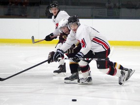 Tyler Murray of the Gananoque Islanders tries to keep himself between the puck and Emerson Moulton of the Athens Aeros on Sunday during their game at the Lou Jeffries Gananoque TLTI Recreation Centre. The Islanders won the game 6-5.