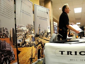 Daryl Dnistransky, recruiting co-ordinator for Trican Well Service Ltd. sells the company to a group of interested job seekers during the job fair at the Holiday Inn on Wednesday. (Adam Jackson/Daily Herald-Tribune)