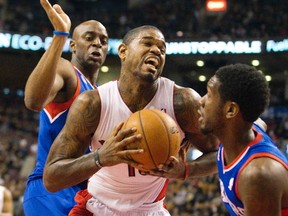 Raptors’ Amir Johnson drives to the hoop past  two 76ers defenders during the first half at the Air Canada Centre last night. (Fred Thornhill/REUTERS)