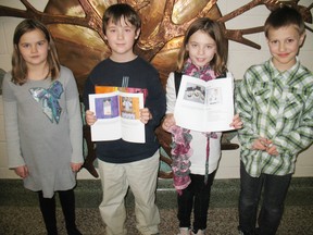 Students in Grade 3 and 4 at Delhi Public School are now published authors thanks to the Write to Give campaign with the World Teacher Aid Foundation. Holding up the books are, from left,  Emily Cree, Riley Coulter, Madison Kungl and Leo VandenBussche.  (SARAH DOKTOR Delhi News-Record)