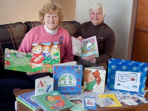 Teresa Dorey and Beryl Jacka display some of the children's books they've collected to be distributed to newborns and toddlers in Lennox & Addington County, through the Retired Women Teachers of Ontario Napanee Branch's Tales and Tunes for Tots program.