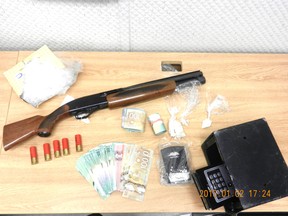 The weapon, drugs and money were displayed by local police after a major bust at a Stony Plain residence over the holidays.