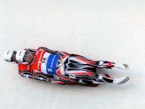 Canadian Tristan Walker and Justin Snith race down the track during the Viessmann double Luge World Cup series in Altenberg, eastern Germany on December 8, 2012. AFP PHOTO / ARNO BURGI  GERMANY OUT