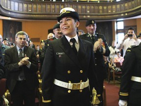 Nicole Shingoose accepts a standing ovation after being commissioned as a navy acting sub-lieutenant Thursday morning. Shingoose, 24, is the first commissioned RMC cadet to graduate from the college's Aboriginal Leadership Opportunity Year.
Elliot Ferguson The Whig-Standard