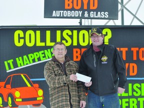 Boyd Autobody & Glass location manager Leonard Roy presents a $2000 cheque to Shane Moffat, BDO Centre for the Commmunity rink manager. The money will be used to help purchase a new ice plant. (Kevin Hirschfield/PORTAGE DAILY GRAPHIC/QMI AGENCY)