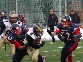 Receiver Tom Hojka can’t escape the grasp of a Camrose Buffalo during the Wolverines loss in the Tier IV league championship game. Photo by Shane Jones/Sherwood Park News/QMI Agemcy