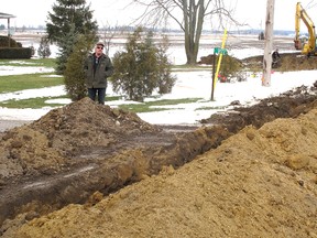 Robert Wilson was surprised and angered to find a trench dug in front of his Horton Line home on Thursday, Jan. 10, 2013, near Blenheim, Ont. He said he received no notice about the trench, which is being used to lay cables that will connect to wind turbines to be erected in the area. (ELLWOOD SHREVE, The Chatham Daily News)