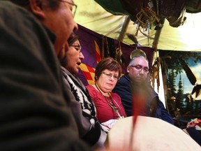 Attawapiskat First Nations Chief Theresa Spence is seen with supporters during a hunger strike inside her teepee on Victoria Island in the Ottawa River next to Parliament Hill in Ottawa Dec 31, 2012. (ANDRE FORGET/QMI AGENCY)