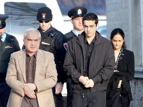 Mohammad Shafia, left, and his wife Tooba Mohammad Yahya, along with their son, Hamed, arrive at a Kingston courthouse in January 2012 during their murder trial. (Whig-Standard file photo)