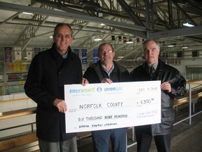 Norfolk County received $6,900 to install energy efficient equipment at three arenas from the Union Gas EnerSmart program. Accepting the cheque is Coun. Jim Oliver, facilities and contract supervisor with Norfolk County, Dave Crandall and Doug Wilson institutional account manager with Union Gas. (SARAH DOKTOR Simcoe Reformer)