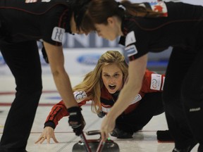 Team North America skip Jennifer Jones watches after delivering a stone as her front end of lead Dawn Askin (right) and second Jill Officer (left) sweep during her game against Team World’s Margaretha Sigfridsson at the Continental Cup yesterday in Penticton, B.C. 9 (MICHAEL BURNS/CCA PHOTO)
