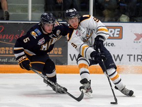 Grande Prairie Storm’s Gus Correale keeps the puck away from Oil Barons defenceman Taylor Graham during a game in October. The Storm will take on the Barons at the Casman Centre Saturday night. TODAY FILE PHOTO