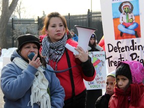 Christine Rogers (pictured in red) is part of a large group from Aamjiwnaang First Nation that made its way to Ottawa Friday. TARA JEFFREY/THE OBSERVER/QMI AGENCY