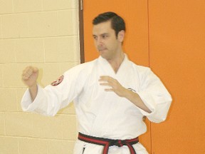 Daniel Whittal goes through a warm-up exercise at Zanshin Dojo, the karate school he operates in Chatham.