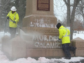 City of Kingston workers remove paint from the base of the Sir John A. Macdonald statue in City park Friday, Jan. 11. Unknown vandals defaced the statue with paint, writing "This is stolen land", "Murderer", and "Colonizer," as well as throwing red paint on the statue itself. Jan. 11, 2013 is the 198th anniversary of the birth of Canada's first prime minister and a special event was held at noon.