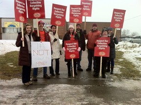 Teachers belonging to the Elementary Teachers Federation of Ontario protest outside J.G Simcoe Public School, legally, during a break on Friday. The Ontario Labour Relations Board ruled early Friday morning that the union's plan to have workers walk out of classes for the entire school day was an illegal strike.