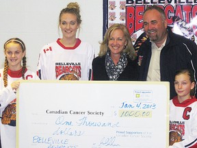 From left, Belleville Bearcats players Ally Soule and Tori Reed, Sue Rollins of the Cancer Society, local MPP Todd Smith and Bearcats player, Haley Robinson, were on hand for a donation of $1,000 by the Belleville and District Girls Minor Hockey Association to the Canadian Cancer Society during the annual Bearcats tournament.