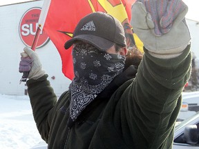 An Aboriginal protester demonstrates outside the offices of the Winnipeg Sun in Winnipeg, Man. Saturday Jan. 12, 2013.
BRIAN DONOGH/WINNIPEG SUN/QMI AGENCY