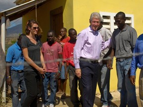 Former U.S. president Bill Clinton (2nd R) visits the Mission of Hope Leveque Housing Community and Agricultural and Technical Research Training Center in Leveque January 12, 2013. (REUTERS/Swoan Parker)