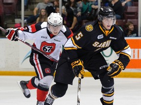 Recently acquired Sarnia Sting defenceman Tyler Hore, right, rushes away from John Urbanic of the Ottawa 67's Saturday at the RBC Centre. Hore was acquired at the trade deadline along with a draft pick for Justice Dundas. PHOTO COURTESY METCALFE PHOTOGRAPHY