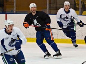 Cam Barker, wearing an NHLPA jersey and Oilers gear, works out with the Canucks at the University of British Columbia in Vancouver, B.C., Jan. 19, 2013. (ANDY CLARK/Reuters)
