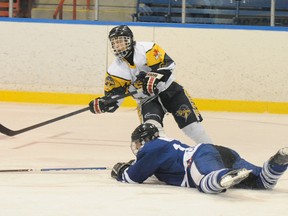 Simcoe's Wade Metz goes for the puck as Woodstock's Bryce Cadwell dives to block it in front of goaltender Micheal Roefs during a game held at Talbot Gardens in Simcoe on Sunday, Jan. 13, 2013. The Storm won 6-2. (SARAH DOKTOR Simcoe Reformer)