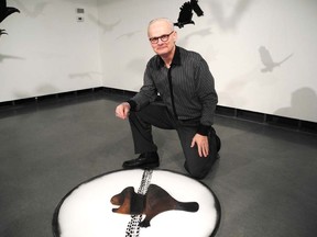 Laura Stricker photo. Ceramic artist Keith Campbell with one of his favourite pieces at the Art Gallery of Sudbury. The road kill beaver was part of Campbell's exhibit, Journey through the Past, held at the gallery until in the spring.