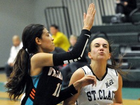 St. Clair's Amber Bechard, right, is fouled by Windsor Valiants' Meighan Boyd during a Junior Elite League of Ontario exhibition basketball game Saturday at St. Clair College's Thames Campus HealthPlex. (MARK MALONE/The Daily News)