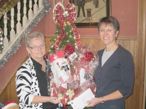 Pictured (left to right) Linda Jackman of the Walker House presents a $600 donation from proceeds from the gift basket fundraiser to Erin Zorzi, SMHF Chair.
