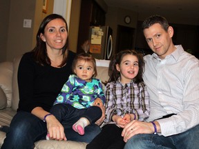 Five-year-old Elle Morton poses at home in Paris with her mother Lory, father Kevin and little sister Paige during an interview about Rett Syndrome, a rare disorder chiefly affecting Elle's speech and hands, on Jan. 10, 2013. Elle will drop the puck at a Paris Mounties game on Jan. 26, 2013, proceeds of which will go to the Ontario Rett Syndrome Association. MICHAEL PEELING/THE PARIS STAR/QMI AGENCY