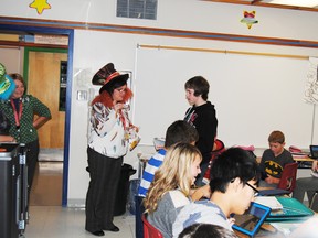 Nicole Moir (l), special education co-ordinator at Percy Baxter School, gives Austin Hallowes (r) a special treat for having his agenda filled out for the week as part of the Renaissance program.
Barry Kerton | Whitecourt Star