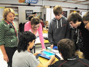 Some of Connor Butler’s classmates crowd in around him as he demonstrates one of the features he is putting into his project about ancient an ancient Aztec empire using an iPad tablet as part of the 1-2-1 Mobile Tablet project.  
Barry Kerton | Whitecourt Star