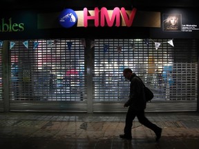 A man passes a branch of British retail music chain HMV on Oxford Street in London January 14, 2013. (REUTERS/Chris Helgren)
