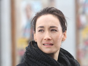 Star Maggie Q waits to appear in a scene for an episode of Nikita that was shot Monday morning in the Springer Market Square.
Michael Lea The Whig-Standard