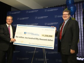Stephen Letwin, left, president and CEO of IAMGOLD Corporation and Gordon Stothart, IAMGOLD executive vice-president and COO, make a cheque presentation at Laurentian University in Sudbury on Monday, January 14, 2013. IAMGOLD provided $1.25 million for a research chair in open-pit mining at Laurentian's Bharti School of Engineering. (JOHN LAPPA)
