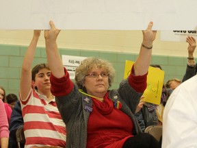 Lindsay Davidson holds up a sign opposing the closure of secondary schools in the central Kingston catchment area of the Limestone District School Board at a committee meeting late last year. A meeting will be held Tuesday night where members of the public can make presentations on the issue.
Danielle VandenBrink/The Whig-Standard