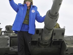 Blue Jays outfielder Colby Rasmus poses after riding in a Leopard 2A4M tank during a recent tour of CFB Edmonton. Rasmus yesterday signed a one-year, $4.675-million US contract with the Jays, avoiding salary arbitration. (Reuters)