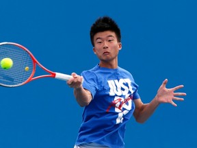 Wu Di of China serves during a practice session at the Australian Open tennis tournament in Melbourne, January 13, 2013. (REUTERS/David Gray)