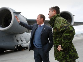 Minister of National Defence Peter MacKay, centre and commanding officer of 8 Wing/CFB Trenton, Ont. look at the C-17 Globemaster aircraft  that Canada decided to send to Mali to assist French troops with transport capacity, Tuesday morning, Jan. 15, 2013.   JEROME LESSARD/The Intelligencer/QMI Agency