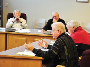 RYAN PAULSEN    Whitewater Region township councillors Joseph Trimm, left, and Allen Dick listen as Cobden and District Recreation Association members David Stewart and Stan Keon make their case that the township should be financially responsible for repairing or replacing a leaky roof at the Cobden Arena at the first council meeting of 2013.