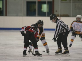 The puck drops during a game between the Fairview Chiropractic Care Novice and the Sexsmith Black during a novice tournament at the Fairplex arena on Saturday, Jan. 12, 2013. (Simon Arseneau/Fairview Post)