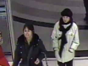Toronto Police released this surveillance image Tuesday, Jan. 15, 2013, of two women sought in the damaging of fur-collared winter coats in the Yonge-Bloor area.