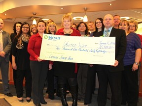 Servus Credit Union staff were on hand at their downtown Fort McMurray branch Tuesday morning to hand over a cheque to the local United Way, which wrapped up its Community Campaign after reaching 99% of their $7.5 million fundraising goal. JORDAN THOMPSON/TODAY STAFF